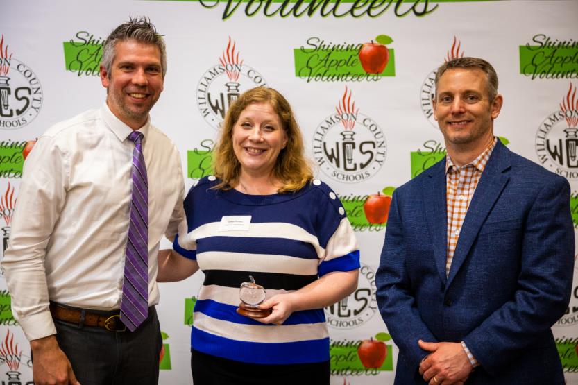Two men and a woman pose for a photo